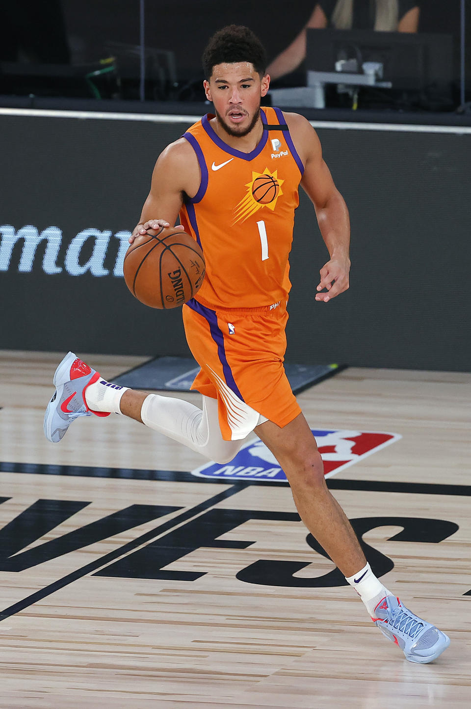 Phoenix Suns' Devin Booker dribbles the ball down court against the Indiana Pacers during the first half of an NBA basketball game Thursday, Aug. 6, 2020, in Lake Buena Vista, Fla. (Kevin C. Cox/Pool Photo via AP)