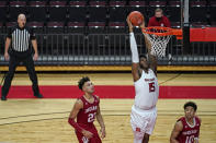 Rutgers center Myles Johnson (15) dunks between Indiana forward Trayce Jackson-Davis (23) and guard Rob Phinisee (10) during the second half of an NCAA college basketball game Wednesday, Feb. 24, 2021, in Piscataway, N.J. (AP Photo/Kathy Willens)