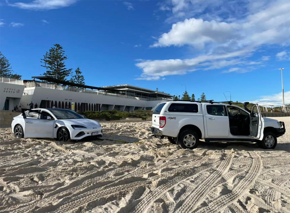 A BYD being towed by a 4x4 on Perth city beach.