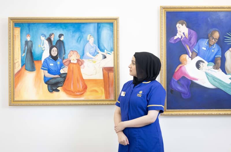 Nurse, Zeb Un Nisa-Ali looks at a reimagined version of Edvard Munch's 'The Dead Mother and The Child' by Lisa Buchanan, commissioned by end-of-life charity Marie Curie to support its flagship fundraiser, the Great Daffodil Appeal, a Mayfair Gallery at 56 Conduit Street in London. Matt Crossick/PA Wire/dpa