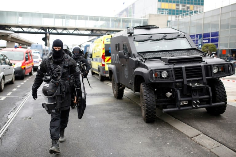 Police officers secure the area at Paris' Orly airport on March 18, 2017, after a man was shot dead when he tried to grab an officer's weapon