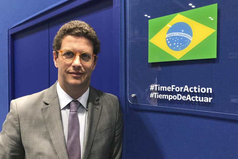 In this photo taken on Saturday Dec. 7, 2019, Brazilian environment Ricardo Salles stands outside the Brazil delegation room at the COP25 U.N. climate talks in Madrid, Spain. Madrid is hosting a two-week global summit aimed at lessening the impact of rising temperatures. (AP Photo/Dorothee Thiesing)