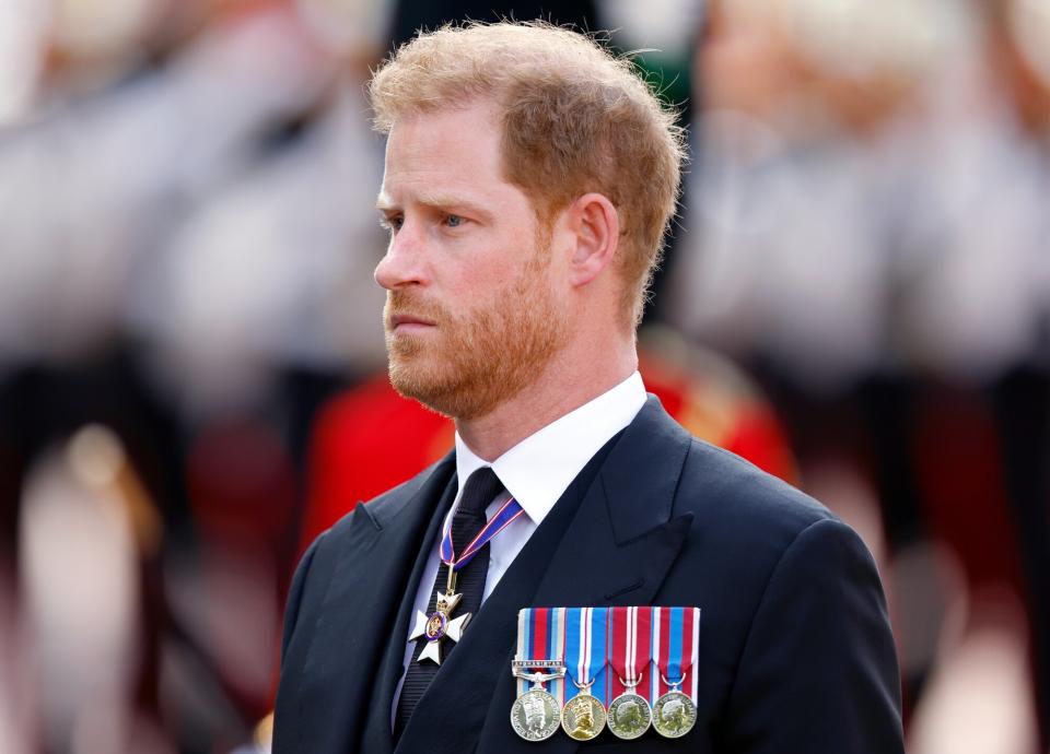 Prince Harry, Duke of Sussex walks behind Queen Elizabeth II's coffin as it is transported on a gun carriage from Buckingham Palace to The Palace of Westminster ahead of her Lying-in-State on September 14, 2022 in London, United Kingdom. Queen Elizabeth II's coffin is taken in procession on a Gun Carriage of The King's Troop Royal Horse Artillery from Buckingham Palace to Westminster Hall where she will lay in state until the early morning of her funeral. Queen Elizabeth II died at Balmoral Castle in Scotland on September 8, 2022, and is succeeded by her eldest son, King Charles III.