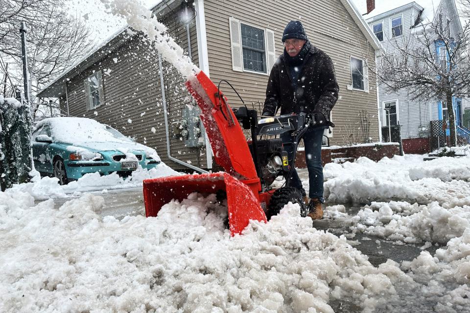 Phil Cloutier removes heavy wet snow after an early-spring Nor'easter, Thursday, April 4, 2024, in Portland, Maine. (AP Photo/David Sharp Sent from my iPhone