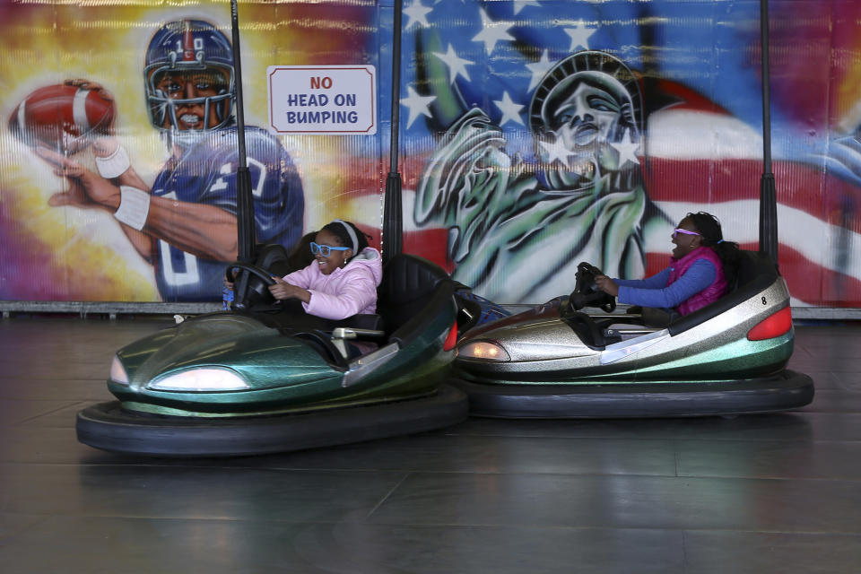 In this Saturday, March 30 2013 photo, children drive the bumper cars at Deno's Famous Wonder Wheel Amusement Park in New York's Coney Island. Despite making the traditional Palm Sunday opening, many of the seasonal businesses at Coney Island are still reeling from the aftermath of Superstorm Sandy. (AP Photo/Mary Altaffer)