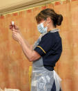 Chief nurse nurse Sam Foster prepares to administer a dose of the Oxford University/AstraZeneca COVID-19 vaccine, at the Churchill Hospital in Oxford, England, Monday, Jan. 4, 2021. England’s National Health Service says a retired maintenance manager has received the first injection of the new vaccine developed by Oxford University and drug giant AstraZeneca. Dialysis patient Brian Pinker became the very first person to be vaccinated by the chief nurse at Oxford University Hospital. (Steve Parsons/Pool Photo via AP)