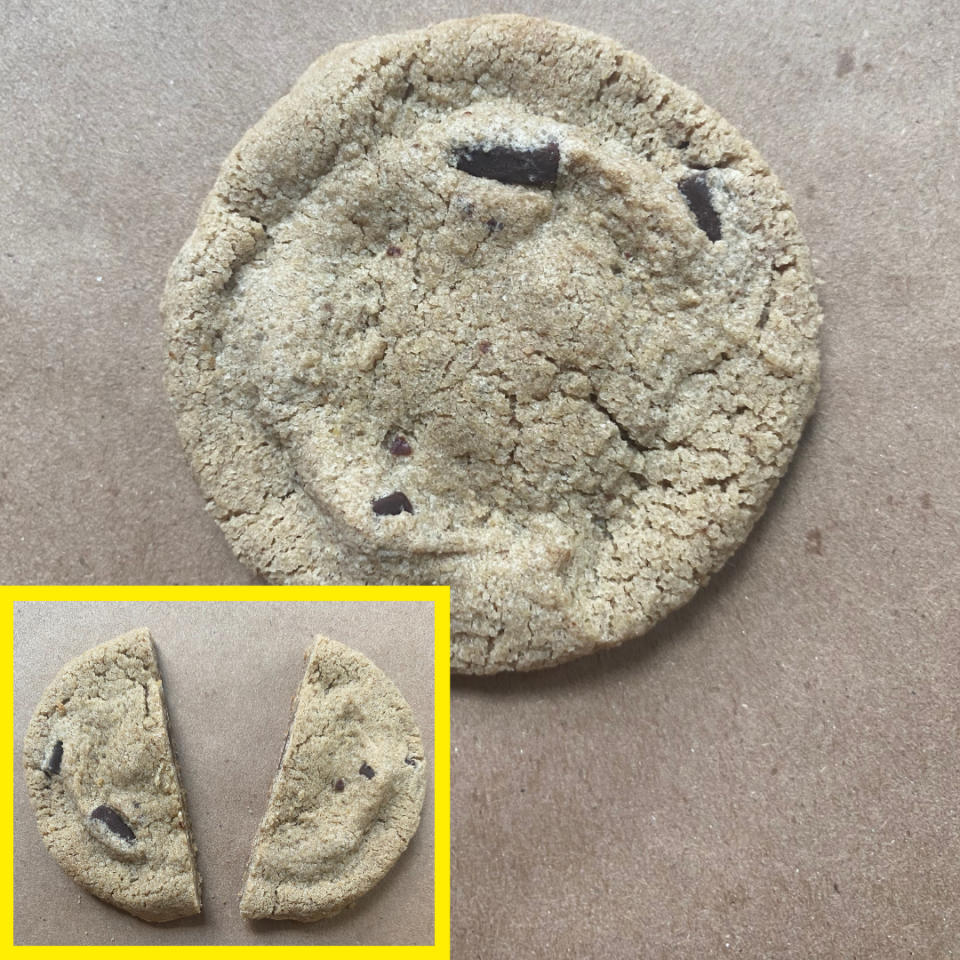 A whole cookie with chocolate chunks, shown next to an inset image of the same cookie broken in half