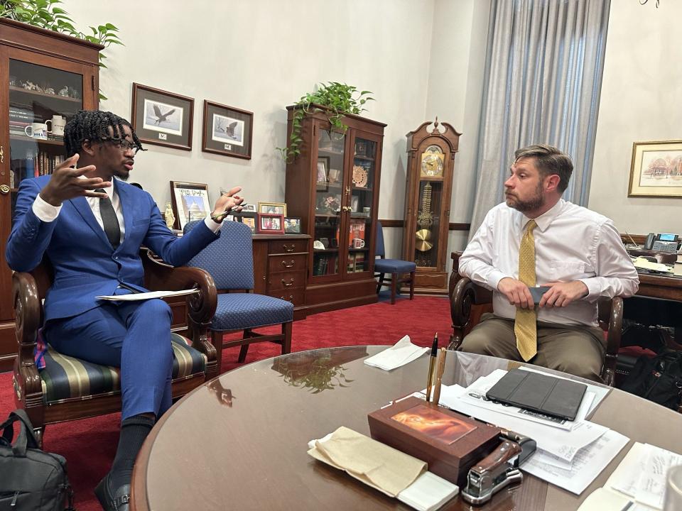 Brandon Washington discussing foster care with a government official in Washington D.C.