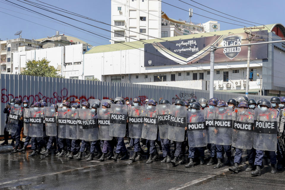 Police in riot gear march to take a position to block demonstrators at an intersection during a protest in Mandalay, Myanmar, Tuesday, Feb. 9, 2021. Police were cracking down on the demonstrators against Myanmar’s military takeover who took to the streets in defiance of new protest bans. (AP Photo)