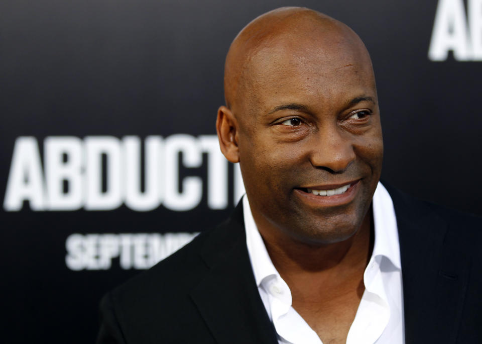 FILE - In this Sept. 15, 2011 file photo, director John Singleton arrives at the premiere of "Abduction" in Los Angeles. Court records show Singleton and Paramount Pictures on Nov. 1, 2012 settled a lawsuit filed by the director/producer that claimed the studio reneged on a contract to allow his company to produce two additional films after the release of 2005's "Hustle & Flow," which received two Oscar nominations. (AP Photo/Matt Sayles, file)