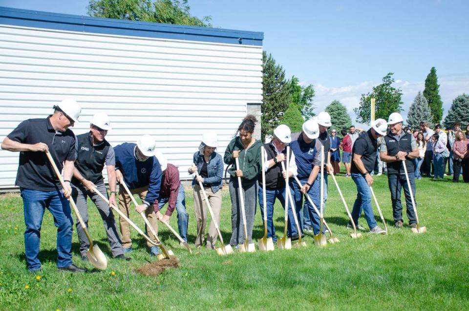 Tri-Cities Prep Catholic High School administrators, school board members and students break ground on the school’s six-classroom construction expansion Monday morning, June 3, 2024, in front of 200 students. Private schools like Tri-Cities Prep have experienced a boom in enrollment since the COVID pandemic.