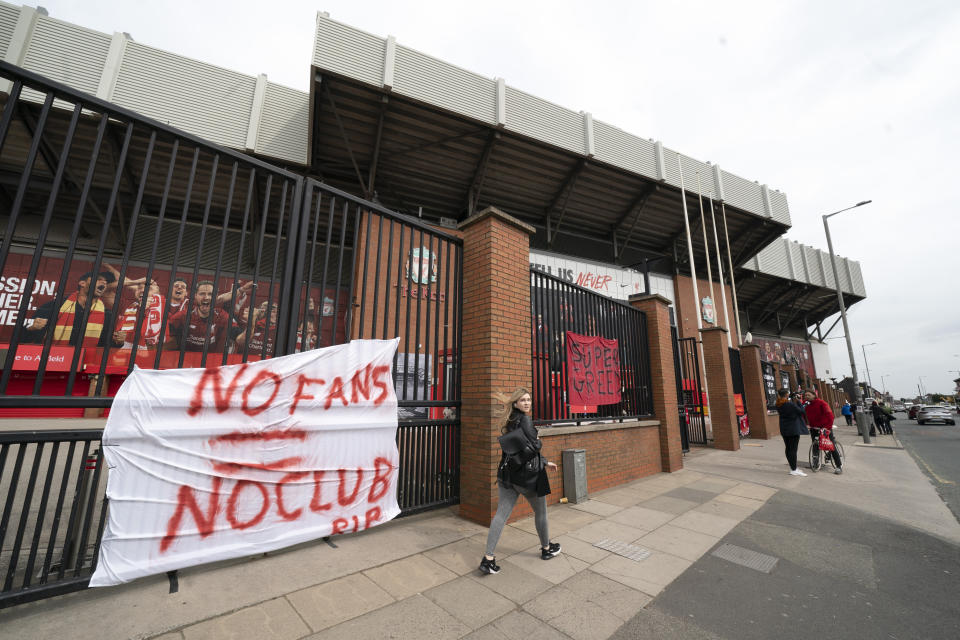 Banners are seen outside Liverpool's Anfield Stadium after the collapse of English involvement in the proposed European Super League, Liverpool, England, Wednesday, April 21, 2021. Liverpool owner John W Henry has apologised to the club's supporters for the "disruption" caused by the proposed European Super League (ESL). (AP Photo/Jon Super)