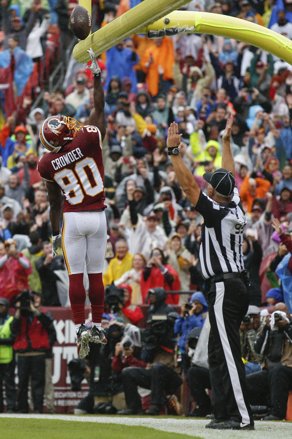 Washington Redskins wide receiver Jamison Crowder (80) tips the ball over the goalposts as he celebrates his touchdown during the first half of an NFL football game against the Green Bay Packers, Sunday, Sept. 23, 2018, in Landover, Md. (AP Photo/Alex Brandon)