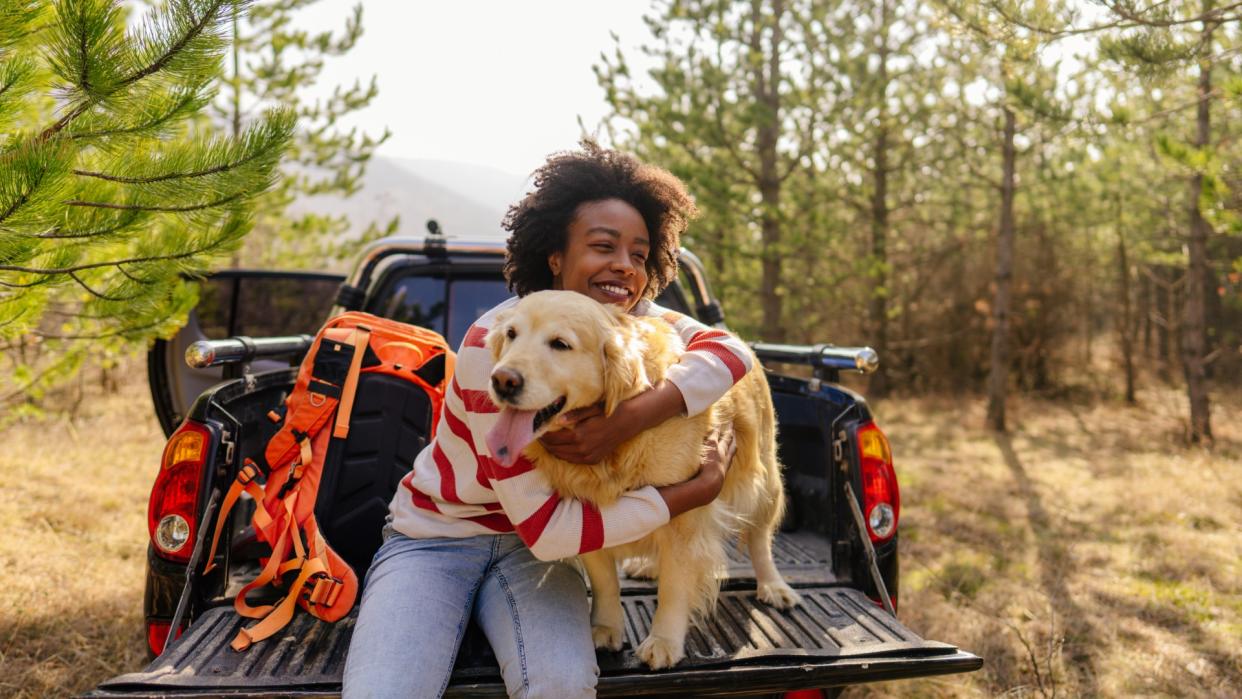  Woman on a road trip with her golden retriever. 