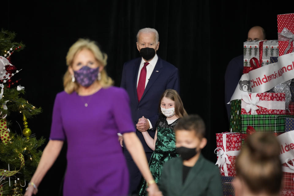 President Joe Biden holds hands with a patient at Children's National Hospital as he arrives with first lady Jill Biden on Friday, Dec. 23, 2022, in Washington. (AP Photo/Andrew Harnik)