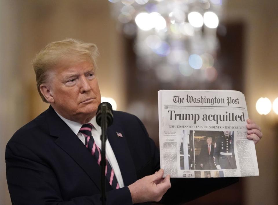 <div class="inline-image__caption"><p>U.S. President Donald Trump held up a copy of The Washington Post as he spoke in the East Room of the White House one day after the U.S. Senate acquitted him on two articles of impeachment, on February 6, 2020 in Washington, DC.</p></div> <div class="inline-image__credit">Drew Angerer/Getty</div>
