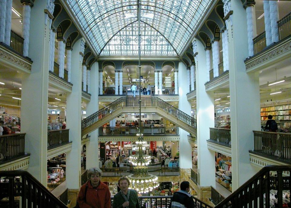 <p>The interior of The Grand Budapest Hotel was shot in location in Gorlitz, Germany. The art department utilized the abandoned structure of an old department store, the Gorlitzer Warenhaus, as the frame to build out both versions of the highly stylized hotel.</p><p>Flocks of fans have re-invigorated tourism in Gorlitz and given the Warenhaus, which sat abandoned for years before the movie, an excuse to re-open as a department store once again. Fans of the movie will recognize the sweeping staircases from the chase scenes and can admire the iconic glass ceiling and chandeliers. </p>