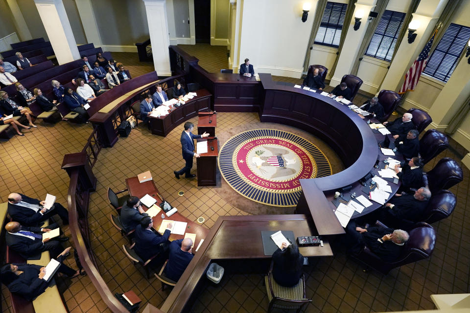 The Mississippi Supreme Court, left, listens as Solicitor General Scott G. Stewart of the Mississippi Attorney General's Office, center, argues for the constitutionality of a Mississippi law that would authorize some judges who would be appointed in a state where most judges are elected, Thursday, July 6, 2023, in Jackson, Miss. (AP Photo/Rogelio V. Solis)