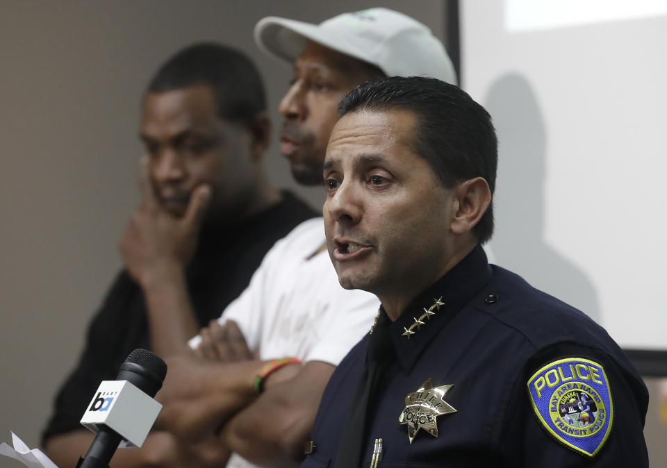 Bay Area Rapid Transit Police Chief Carlos Rojas, right, speaks at a news conference in Oakland, Calif., Monday, July 23, 2018. A man fatally stabbed an 18-year-old woman in the neck and wounded her sister as they exited a train at a Northern California subway station in what officials said Monday appeared to be a random attack. (AP Photo/Jeff Chiu)