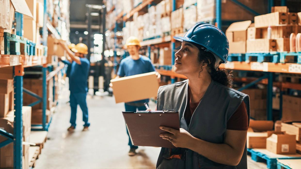 Close up of a group of workers working in a warehouse.