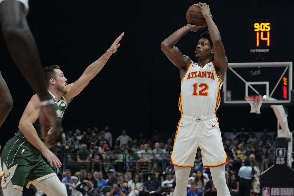 De'Andre Hunter of Atlanta Hawks shoots by Pat Connaughton of Milwaukee Bucks during a preseason NBA basketball game in Abu Dhabi, United Arab Emirates, Saturday, Oct. 8, 2022. (AP Photo/Kamran Jebreili)