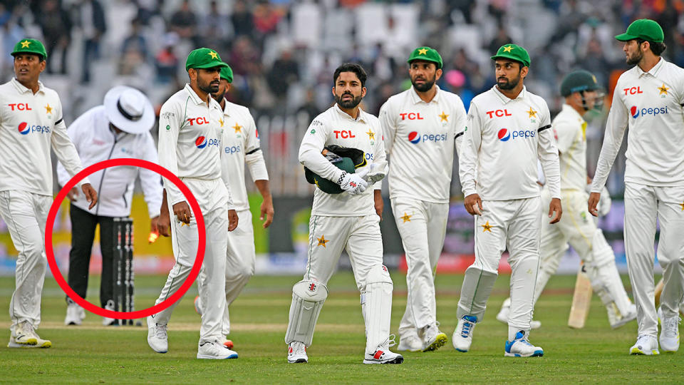 Pictured here, the umpire removes the bails as bad light forces a premature end to day two of Pakistan's opening Test against Australia.