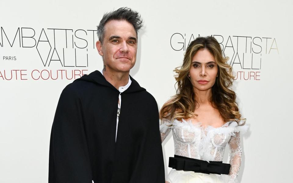 Williams and his wife Ayda Field at the Giambattista Valli show during Paris Fashion Week 2022 - Shuttershock