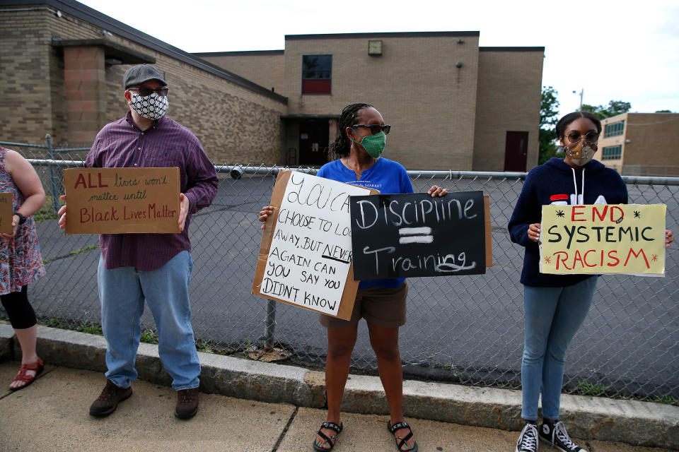 Andrea and Thora Henry protest with others outside of Mystic Valley Charter School in Malden on July 1, 2020<span class="copyright">Jessica Rinaldi—The Boston Globe/Getty Images</span>