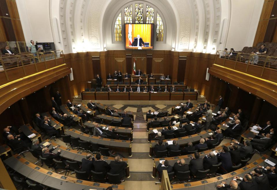 FILE - In this May 31, 2013, file photo, Lebanese lawmakers meet in the Lebanese Parliament during a session to debate whether to extend their term 17 months, in Beirut, Lebanon. Since the current parliament was elected in June 2009, the lawmakers have met 21 times to pass 169 laws, mostly related to raise government and civil servants' salaries, receive foreign aid and amend election law that will enable their re-election. In 2013, Lebanon's lawmakers only met twice to pass two laws, one of which was to extended their mandate for 18 months. (AP Photo/Hussein Malla, File)