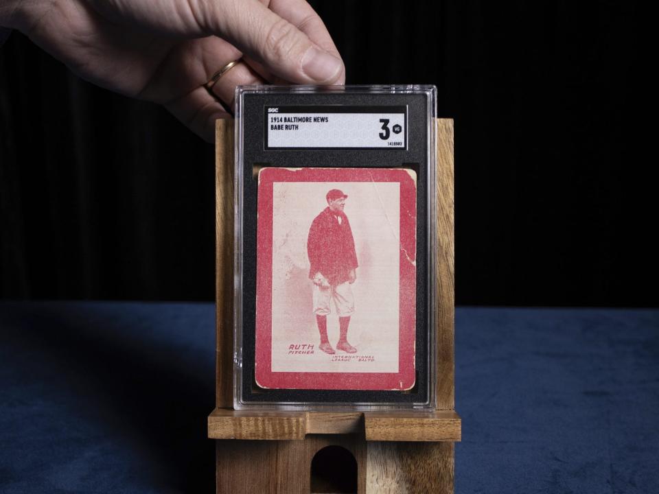 Brian Dwyer of Robert Edward Auctions shows a 1914 Baltimore News baseball card featuring a 19-year-old Babe Ruth in his rookie year in Chester, New Jersey, on Monday, November 20, 2023