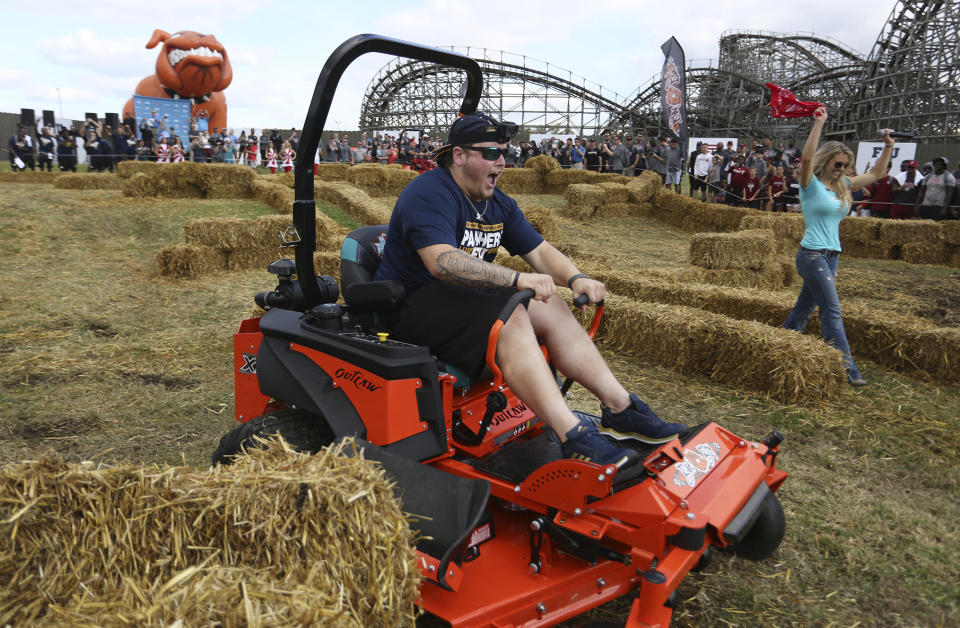 Florida International University center Shane McGough crosses the finish line before his Temple University counterpart during the Bad Boy Mowers Championship Race at Busch Gardens Monday, Dec. 18, 2017. (James Borchuck/The Tampa Bay Times via AP)