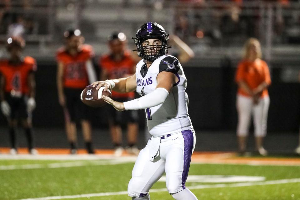 Hallsville quarterback Brayden Matheney winds up to throw a pass during a football game on August 25, 2023, at Palmyra High School.