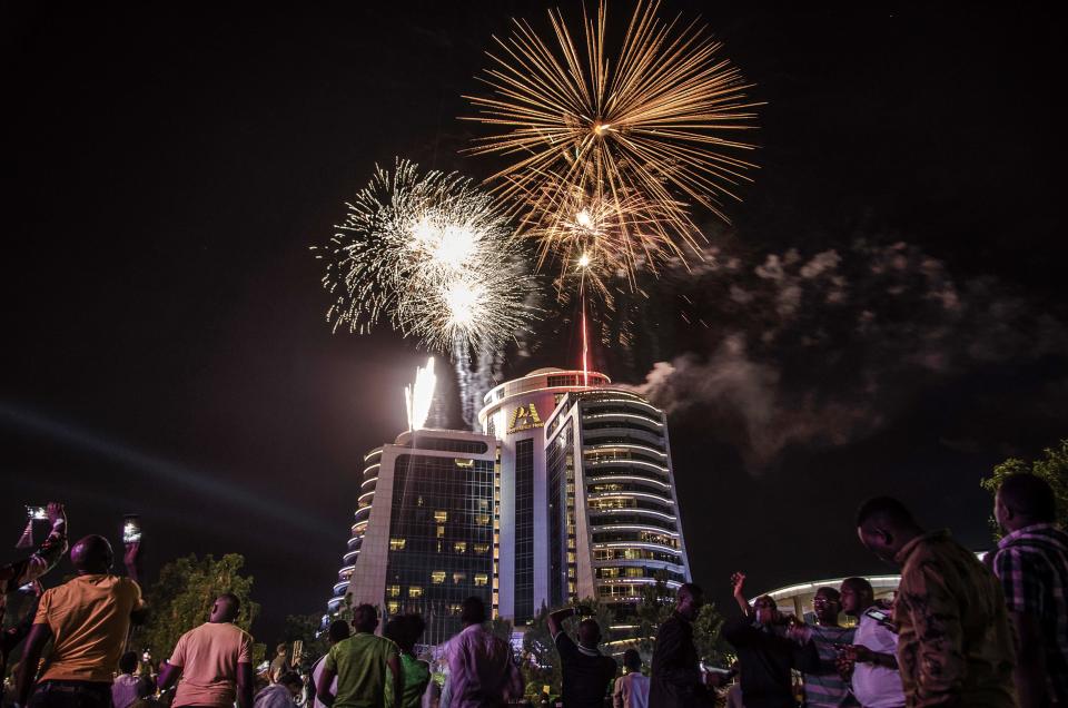 People watch fireworks launching at the Pearl of Africa Hotel to celebrate a New Year in Kampala on January 1, 2019. (Photo by Badru Katumba / AFP)BADRU KATUMBA/AFP/Getty Images ORIG FILE ID: AFP_1BX0XE