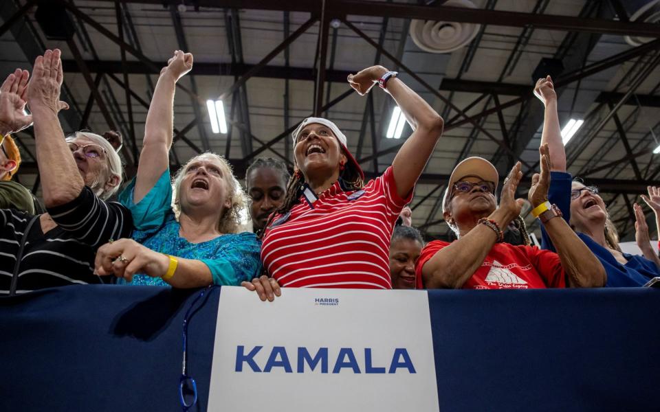 Supporters of Kamala Harris cheer at a campaign event in West Allis, Wisconsin last night