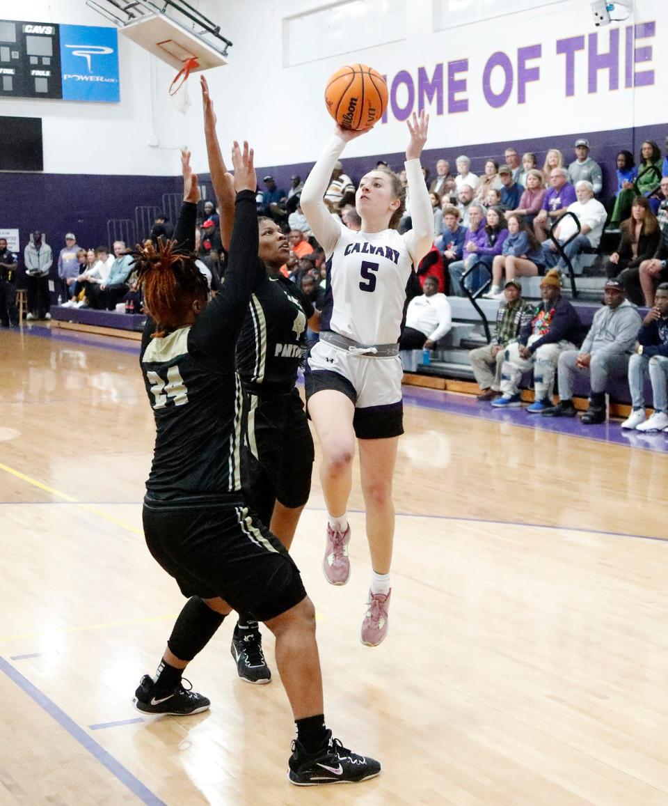 Calvary Day's Hannah Cail pulls up for a basket over Liberty County's Destiny Grider and Keyera Grant during the Region 3-3A championship game.