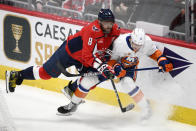 Washington Capitals left wing Alex Ovechkin (8) collides with New York Islanders defenseman Ryan Pulock (6) during the third period of an NHL hockey game, Wednesday, March 29, 2023, in Washington. The Islanders won 2-1 in a shootout. (AP Photo/Nick Wass)