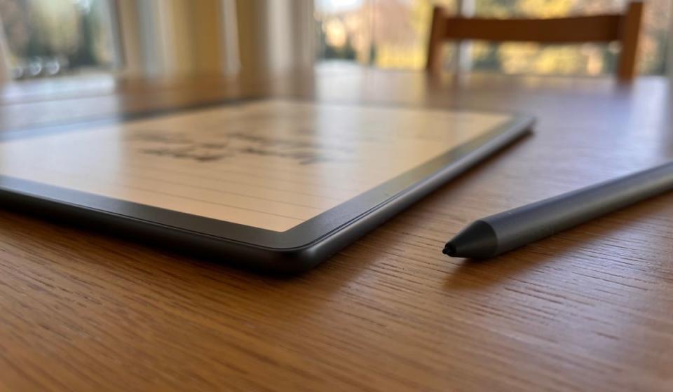 The Scribe laying flat on a table, with its pen alongside.