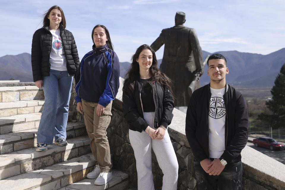 From left, Fiorela Hoxhaj, 18, Aldina Demiraj, 17, Marsida Qelia, 17, Jetlir Halucaj, 16, pose for a picture in Bajram Curri town, 240 kilometers (150 miles) northern of Tirana, Albania, Tuesday, March 14, 2023. Thousands of young Albanians have crossed the English Channel in recent years to seek a new life in the U.K. Their dangerous journey in small boats or inflatable dinghies reflects Albania's anemic economy and a younger generation’s longing for fresh opportunities. (AP Photo/Franc Zhurda)