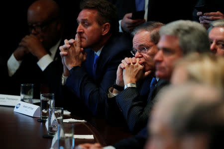 U.S. Representative Bennie Thompson (D-MS), Senator Jeff Flake (R-AZ) and Senator Bob Menendez (D-NJ) listen as President Donald Trump speaks during a bipartisan meeting with legislators on immigration reform at the White House in Washington, U.S. January 9, 2018. REUTERS/Jonathan Ernst