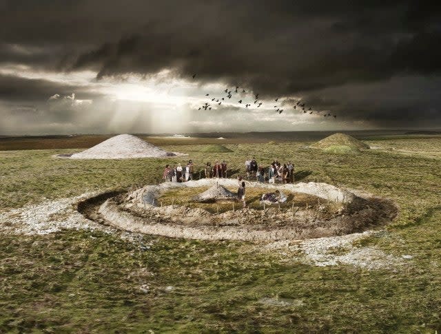 This artist's impression shows a funeral ceremony at an Early Bronze Age burial enclosure: © Historic England