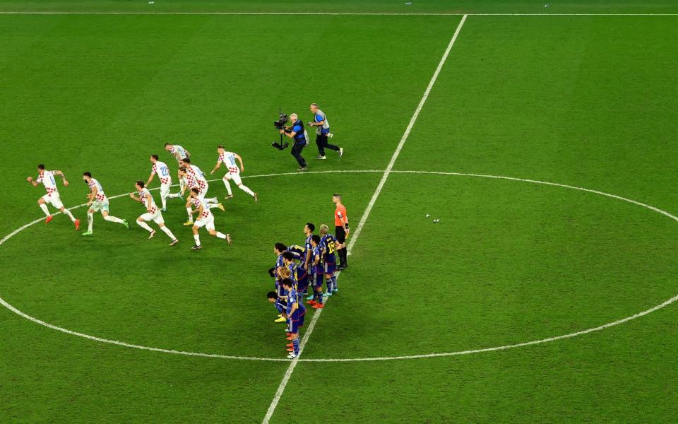 Croatia players celebrate after winning the penalty shootout as Japan players look dejected - REUTERS/Lee Smith