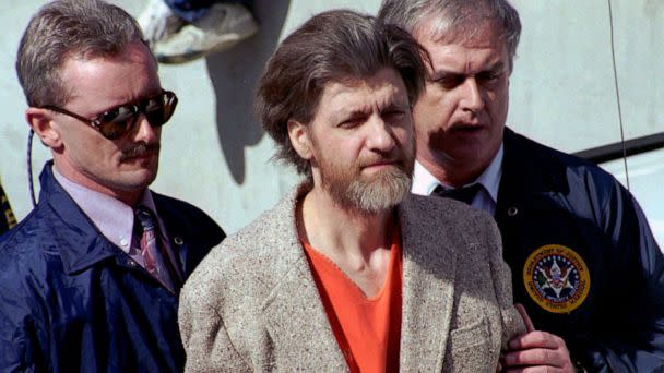 PHOTO: In this April 4, 1996 file photo, Ted Kaczynski, better known as the Unabomber, is flanked by federal agents as he is led to a car from the federal courthouse in Helena, Mont. (John Youngbear/AP, FILE)