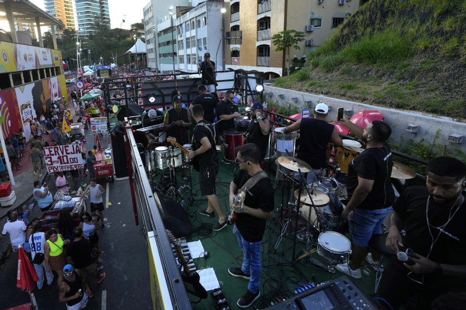 Musicians and technicians set up on top of a sound truck referred to as an electric trio, in Salvador, Bahia state, Brazil, Sunday, Feb. 4, 2024. In the seven decades since the first one hit Brazil's streets, they have become a fixture of the country's annual Carnival festivities. (AP Photo/Eraldo Peres)