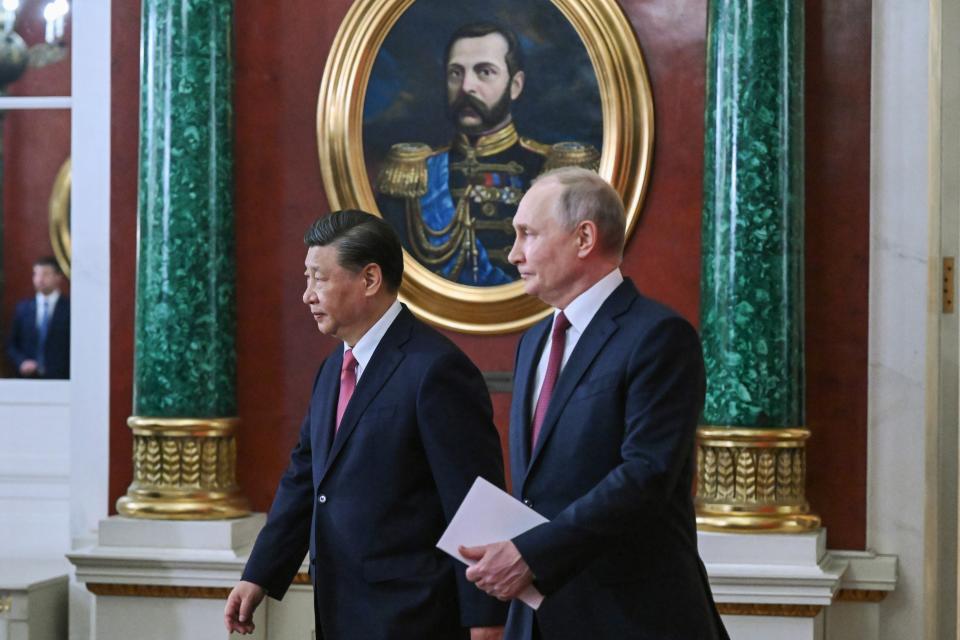 Russian President Vladimir Putin, right, and Chinese President Xi Jinping arrive to attend a signing ceremony following their talks at The Grand Kremlin Palace, in Moscow, Russia, Tuesday, March 21, 2023. (Grigory Sysoyev, Sputnik, Kremlin Pool Photo via AP)