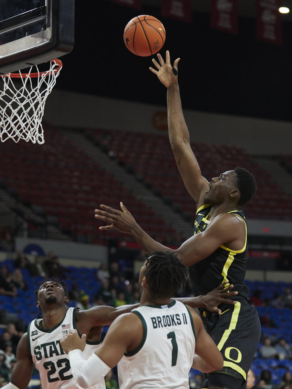 Oregon center N'Faly Dante, right, shoots over Michigan State guard Pierre Brooks (1) and center Mady Sissoko (22) during the first half of an NCAA college basketball game in the Phil Knight Invitational tournament in Portland, Ore., Friday, Nov. 25, 2022. (AP Photo/Craig Mitchelldyer)