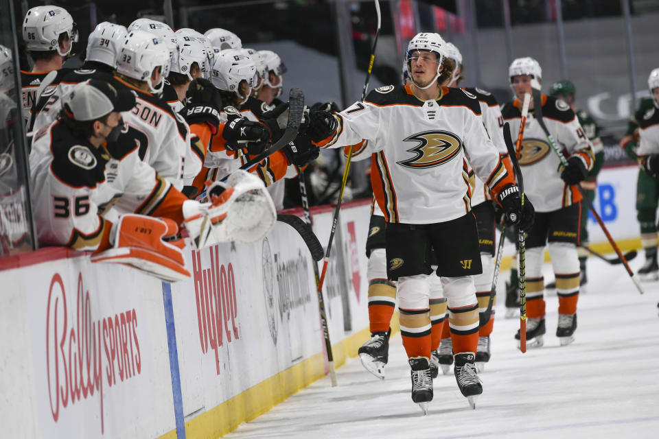 Anaheim Ducks center Rickard Rakell, right, celebrates with the bench after scoring a goal against the Minnesota Wild during the first period of an NHL hockey game Saturday, May 8, 2021, in St. Paul, Minn. (AP Photo/Craig Lassig)