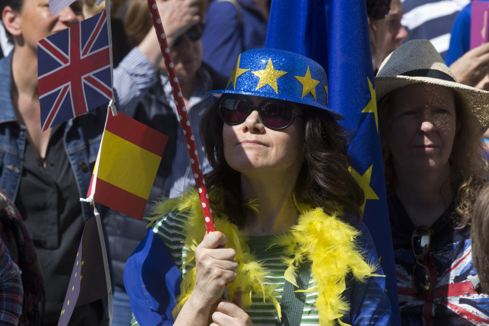 A woman wearing a hat with the EU flag, holds a pole with a British and Spanish flag during an anti Brexit protest in the Plaza Margaret Thatcher in Madrid, Spain, Saturday, March 23, 2019. Coinciding with the anti Brexit march in London, the Eurocitizens campaign group have organized a protest in the Spanish capital calling for the protection of British citizens living in Spain while asking for a second Brexit referendum. (AP Photo/Paul White)