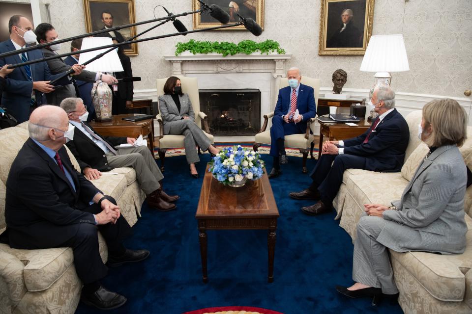 US President Joe Biden speaks alongside US Vice President Kamala Harris (3rd L), as he holds a meeting with US Senators, including Ben Cardin (L), Democrat of Maryland,  Jim Inhofe (2nd L), Republican of Oklahoma, Tom Carper (2nd R), Democrat of Delaware, and Shelley Moore Capito (R), Republican of West Virginia, about infrastructure improvements, in the Oval Office of the White House in Washington, DC, February 11, 2021. (Photo by SAUL LOEB / AFP) (Photo by SAUL LOEB/AFP via Getty Images)