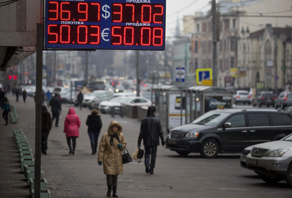 People walk past a currency exchange office in downtown Moscow, Russia, Monday, March 3, 2014. Russia's markets have dropped about 10 percent and its currency has fallen to its lowest point ever against the dollar and the euro because of the crisis in neighboring Ukraine. Russia intervened over the weekend to take control of Crimea, a Ukrainian peninsula with strategic importance, and the new government in Kiev fears a wider invasion. (AP Photo/Alexander Zemlianichenko)