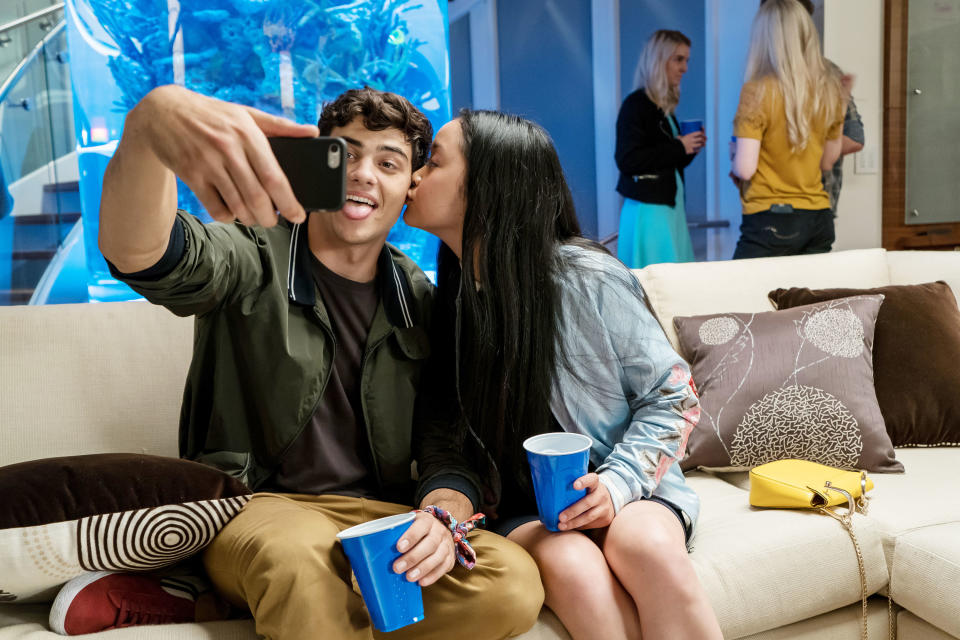 Noah Centineo as Peter taking a selfie as Lana as Lara kisses him